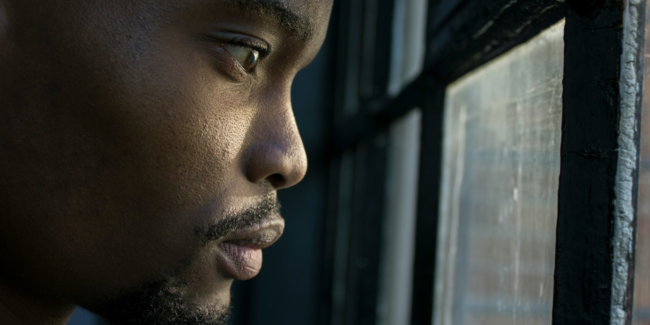 Man Looking Out Window